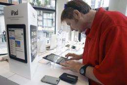 A man tests the Apple iPad at an electronics store in Brussels