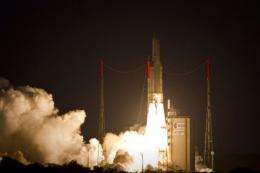 An Ariane 5 rocket takes off, on its way to place two communications satellites into geostationary orbit