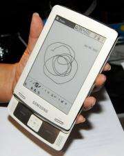 An attendee examines the new E6 e-book reader by Samsung