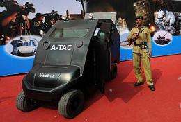 An Indian paramilitary soldier stands guard by an Anti-Terrorist Assault Cart (ATAC)