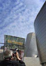 A photographer takes a picture of the poster announcing a Guggenheim Bilbao museum temporary exhibition