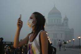 A Russian girl wears a mask to protect herself from the forest fire smog in Moscow