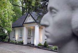 A sculpture of Polish composer Fryderyk Chopin is seen in front of a cottage in Zelazowa Wola