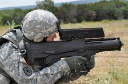 A soldier aims an XM25 weapon system at Aberdeen Test Center, Maryland
