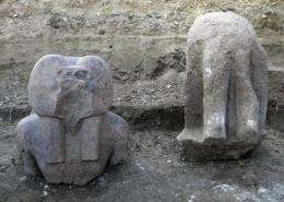A statue of the ancient god Hapi (L), one of the four sons of Horus, depicted here as a baboon