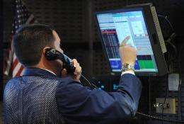 A stock specialist works at a trading post on the floor of the New York Stock Exchange