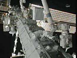 Astronauts (C) from the International Space Station out on a spacewalk on August 16
