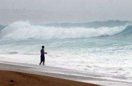 A tourist takes a dip into the sea in Cabo San Lucas, Baja California, Mexico as a hurricane approaches in 2006