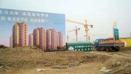 A truck drives into the site of an "eco-city" which is now under construction near the port city of Tianjin