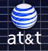 AT&T adds record number of iPhones, posts tax gain