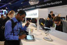 Attendees test new tablet and notebook computers at the 2010 International Consumer Electronics Show