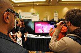 Attendees watch 3D entertainment at the Sensio media display