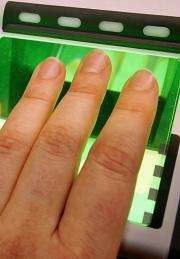 A woman uses a fingerprint scanner