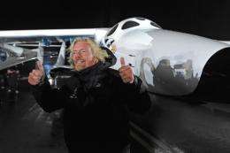 Billionaire entrepreneur Richard Branson gives the thumbs up in front Virgin Galactic's SpaceShipTwo