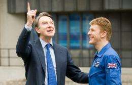 Business Secretary Peter Mandelson (L) speaks with astronaut Major Timothy Peake