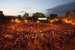 Egyptian demonstrators gather at dusk in Tahrir Square in Cairo