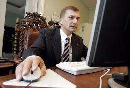 Estonian Prime Minister Andrus Ansip tries out Internet voting in Tallinn as he casts his ballot from his office in 2005