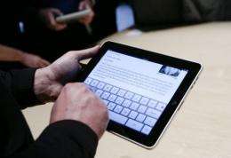 Event guests play with the new Apple iPad during an Apple Special Event in San Francisco in January.