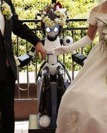 Eyes flashing, robot conducts wedding in Tokyo (AP)