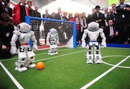 Four pint-sized robot footballers attracted huge cheering crowds