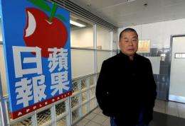 Hong Kong media tycoon Jimmy Lai poses outside his company's headquarters