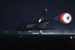 In rare night landing, space shuttle back on Earth (AP)