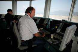 Inside the hot and stuffy glass bulb of the Hong Kong airport control tower, a dozen staff monitor flights