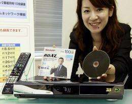 Japanese electronics giant Sharp employee displays the BDXL standard Blu-ray disc and its recorder