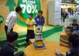 Japanese school children visit a educational workshop at the Eco-Products 2010 exhibition