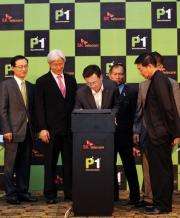 Ki Haeng Cho (C), President of SK Telecommunication, signs a memorundum in Kuala Lumpur