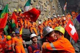 Miners celebrate after completing the world's longest tunnel beneath the Swiss Alps