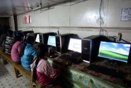 Nepalese girls surf the Internet in the village of Nagi, some 200 kms west of Kathmand