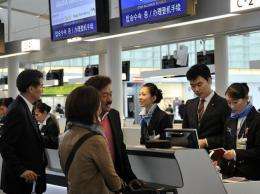 Passengers check in at a counter