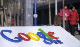 Pedestrians pass the Google logo outside the web titan's Beijing headquarters