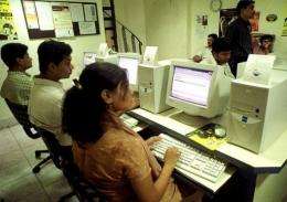 People browse the net at a cyber cafe in Calcutta