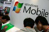 People look at Microsoft's Window Mobile smart phones at an exhibition in Beijing
