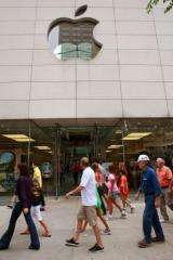 People walk past the Apple store on Michigan Avenue in Chicago