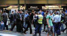Police stand outside an Apple shop as the iPhone 4 is launched in Sydney