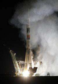 Rocket with US-Russian crew blasts off (AP)