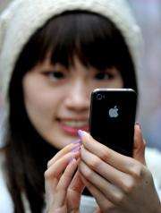 Sydney resident May Tong uses her new Apple iPhone 4