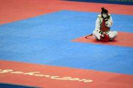 Taiwan's taekwondo hopeful Yang Shu-chun sits on the mat, refusing to leave in protest