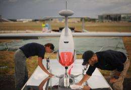 Technicians clean a QinetiQ Aerostar Tactical UAV unmanned drone