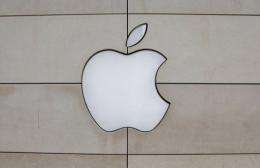 The apple logo hangs outside the Apple retail store along the Magnificent Mile in Chicago