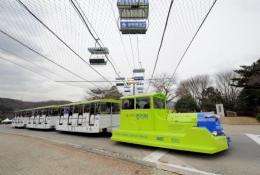 The Online Electric Vehicle (OLEV), towing three buses, went into service at an amusement park in southern Seoul