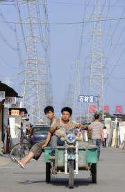 Traffic passes below power lines in Beijing