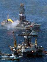 Transocean Development Driller III (R) and the Discoverer Enterprise drilling rig continue efforts to recover oil