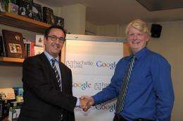 US Google Books head Dan Clancy (R) shakes hand with France's biggest publisher Hachette Livre head Arnaud Nourry