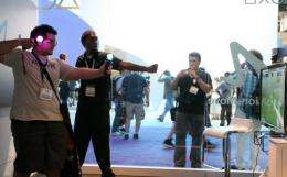 Visitors are seen trying out games at the Electronic Entertainment Expo in Los Angeles