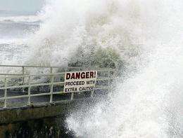 Waves slam over a seawall in Jupiter, Florida, during a hurricane